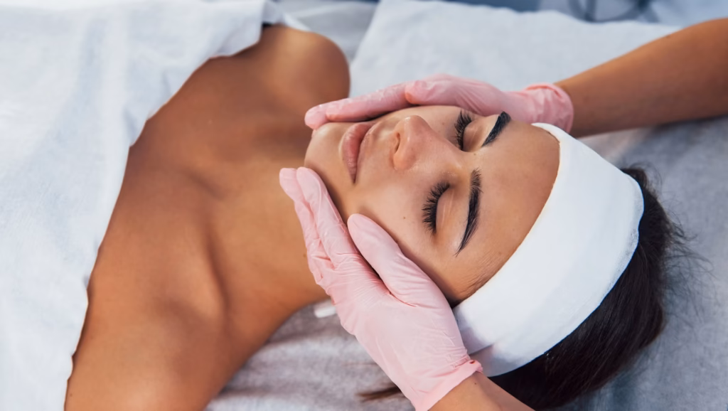 Client receiving a facial treatment while wearing a headband